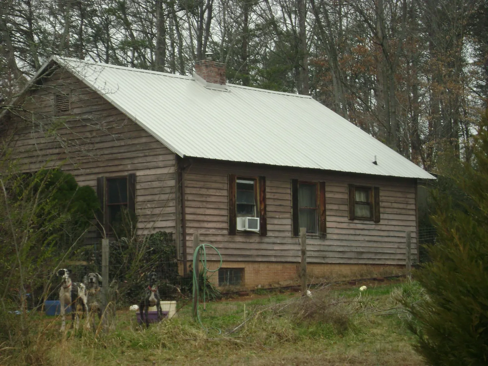 White metal roof on an old wood sided farmhouse, from a Metal Roof Installation job in Alum Bank